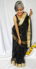 Load image into Gallery viewer, Chanchal, beautiful, party wear, festive wear, black, handloom, Chanderi silk cotton saree with silver golden traditional round zari butas, elegant pallu with flower shaped buta in silver and golden zari.