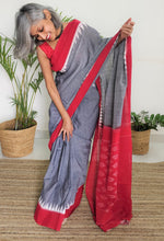 Load image into Gallery viewer, Beautiful, grey red Ikat soft cotton saree, gorgeous. elegant, handloom, festive wear, Durga puja, Ganapati, office wear, ethnic collection, traditional dress, Chanchal bringing art to life.